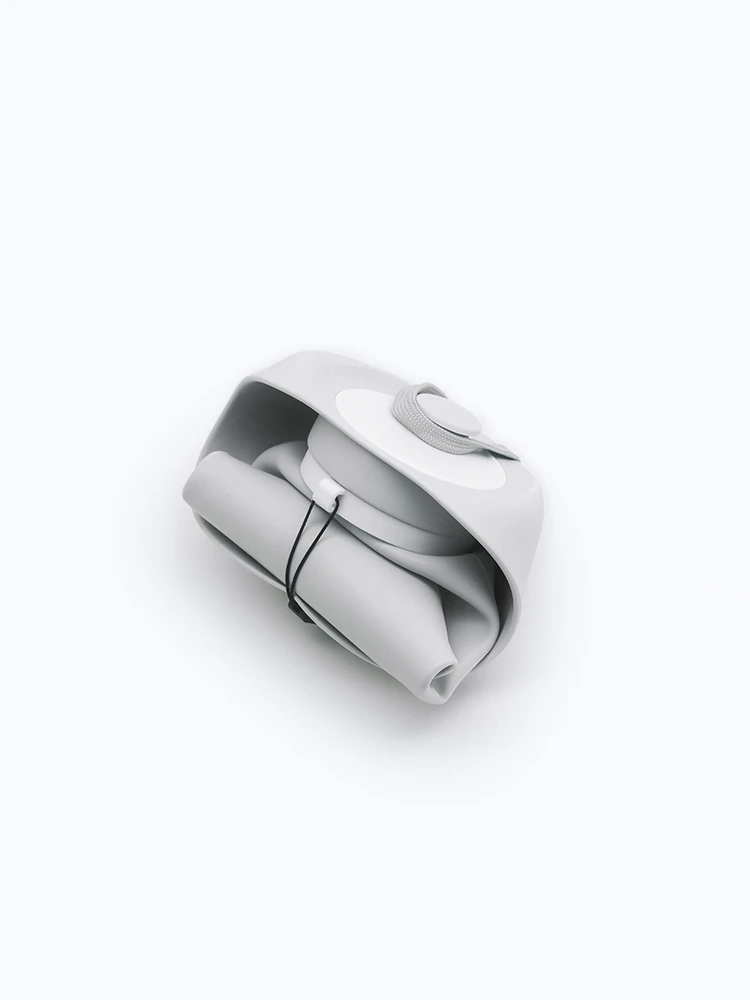 Gray foldable dog water bottle collapsed flat on white background