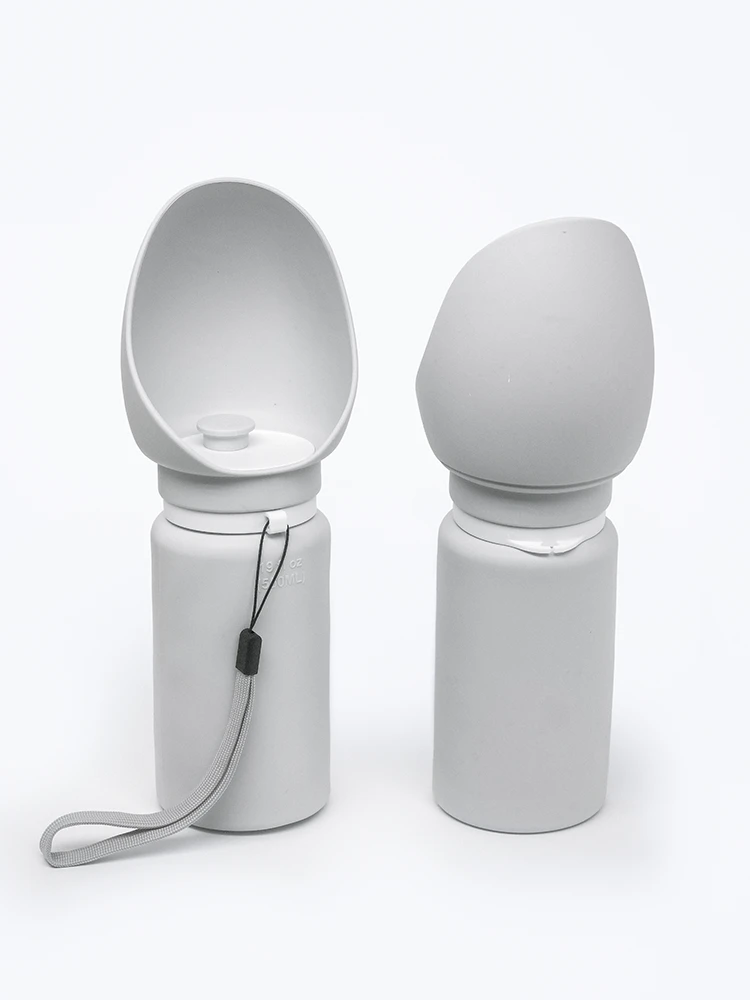 Two gray silicone dog water bottles standing front and back on white background