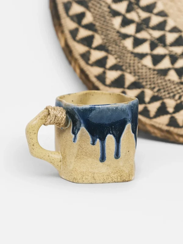 Handmade turmeric glaze ceramic mug with indigo blue drip and hemp handle