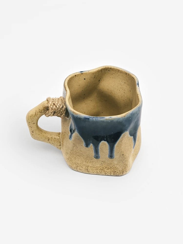 Irregular ceramic mug with turmeric glaze and indigo drip detail
