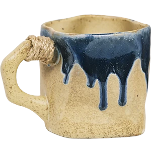 Handmade turmeric glaze ceramic mug with indigo blue drip and hemp handle
