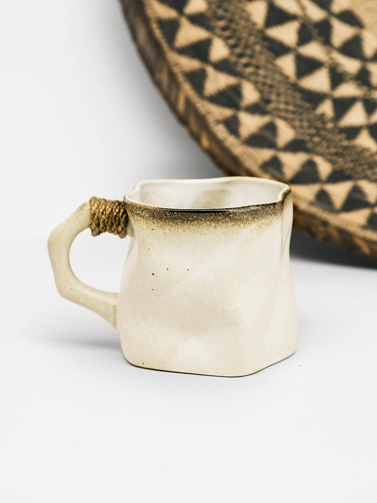 Handmade cream ceramic mug with brown rim and hemp wrapped handle