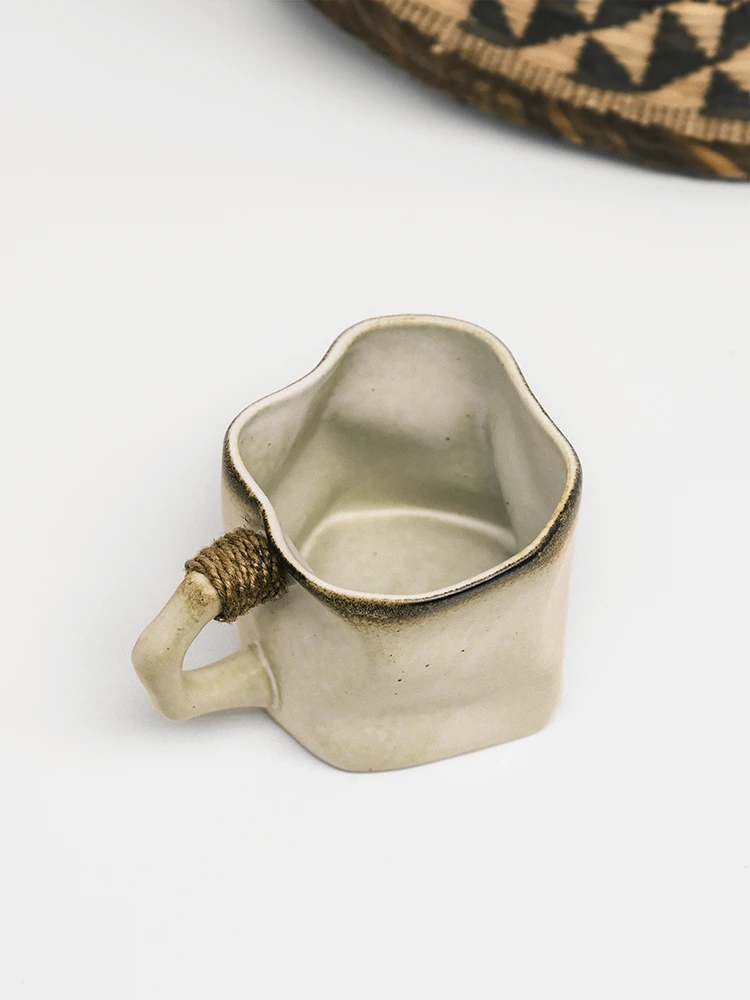 Asymmetric handmade ceramic mug showing organic sculpted shape