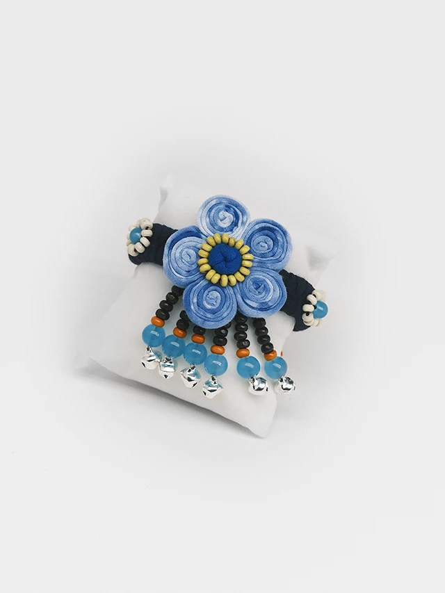 Indigo tie dye fabric bracelet with beaded flower and small ring bells