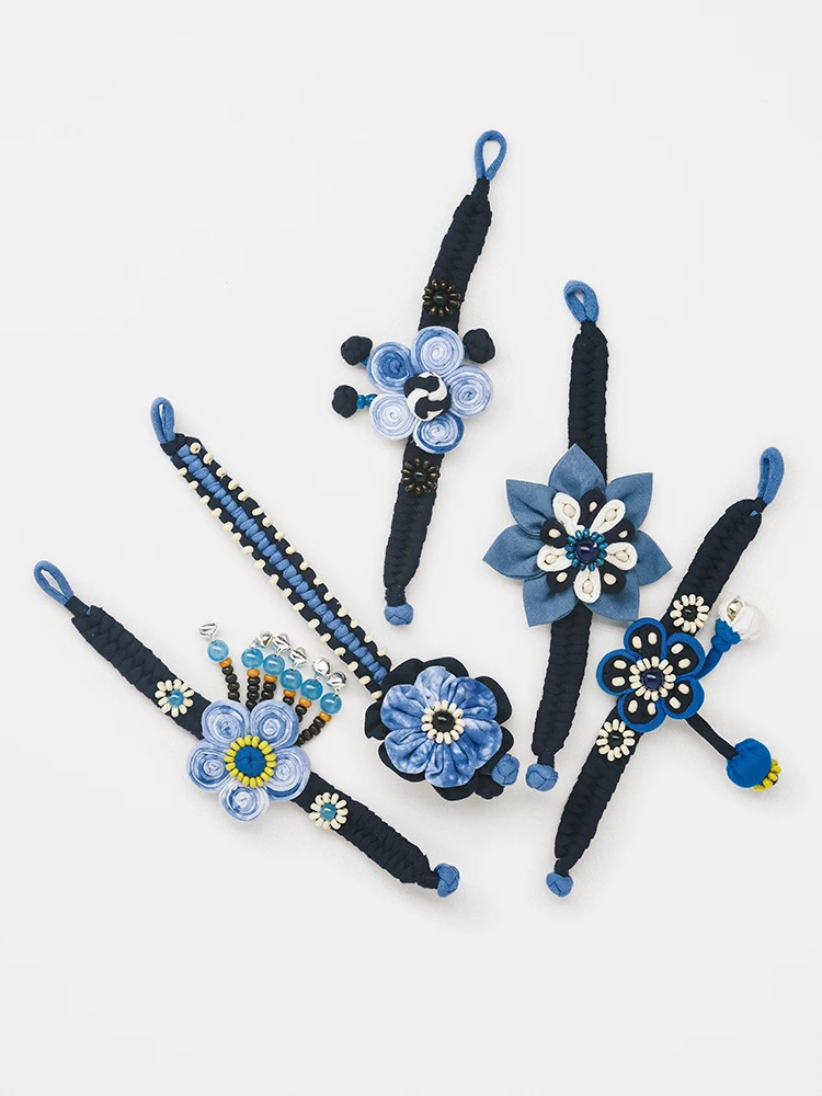 Group of indigo tie dye fabric bracelets with beaded ethnic fusion details laid flat