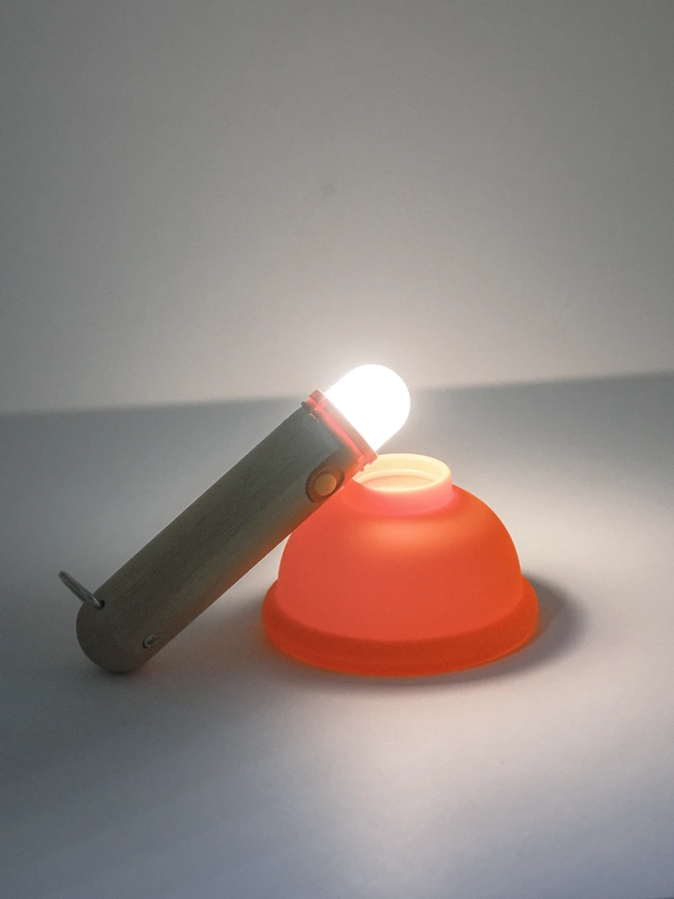 Wooden handle rechargeable flashlight glowing in dark room