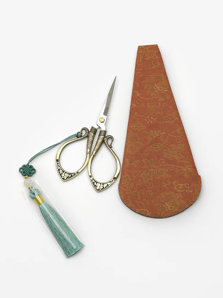 Vintage iron scissors with red fabric pouch