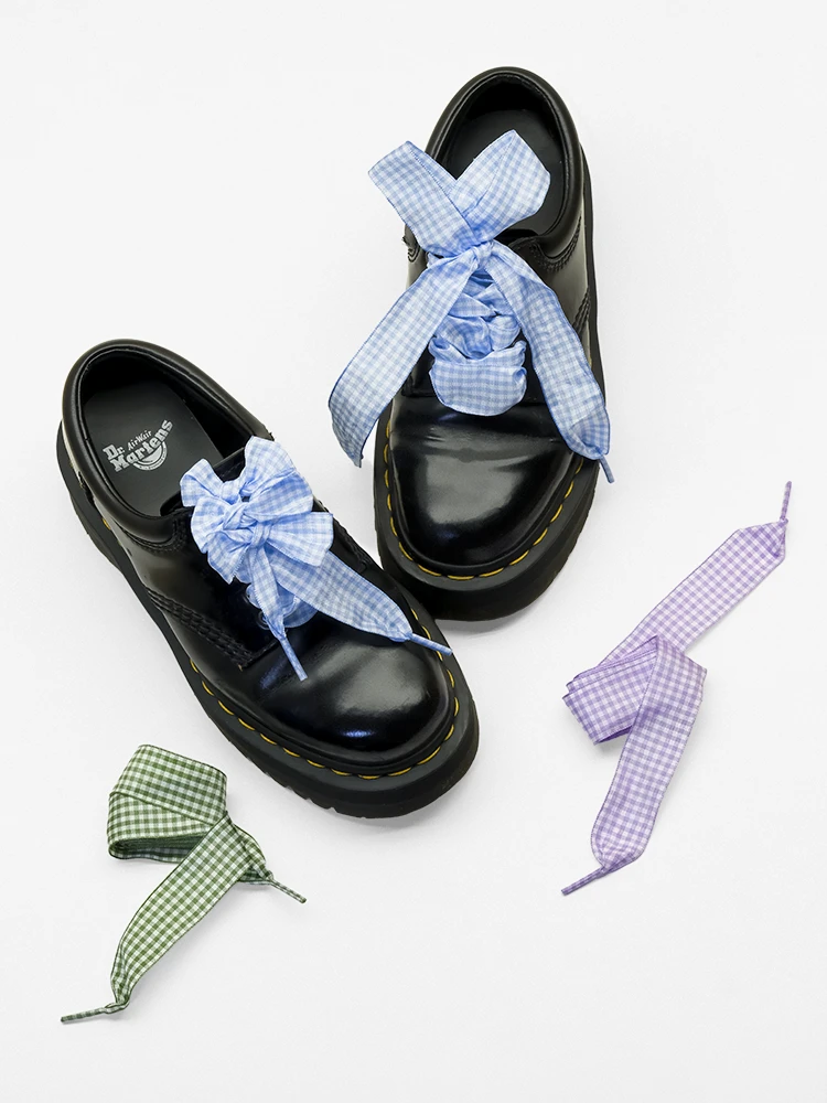 Sky blue gingham shoelaces on black leather shoes