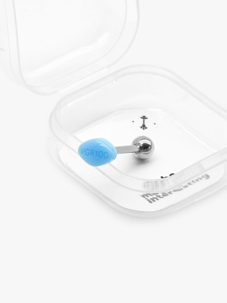 Cyan blue pill shaped lip piercing with VGR100 text