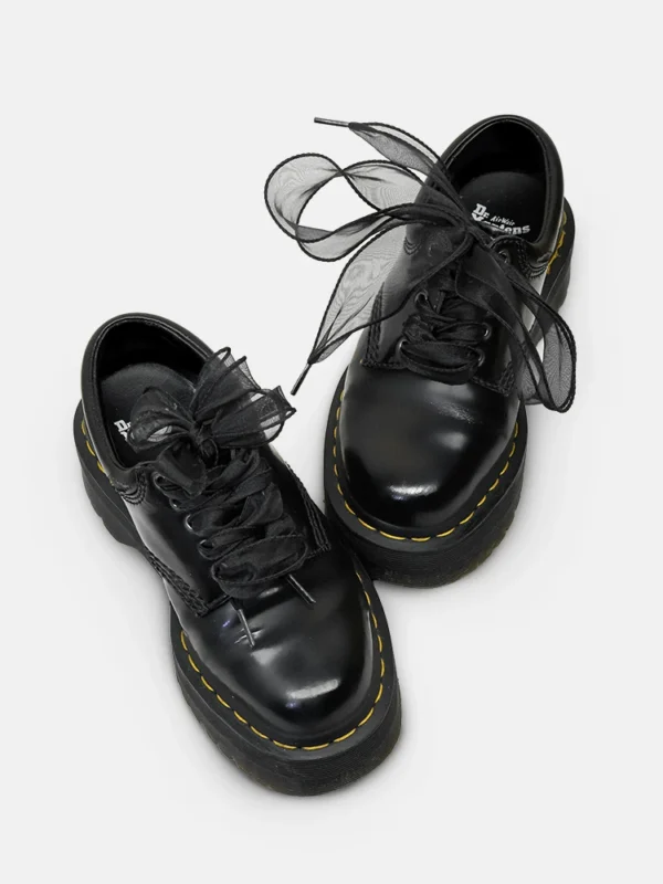 Black wide satin shoelaces on low leather shoes